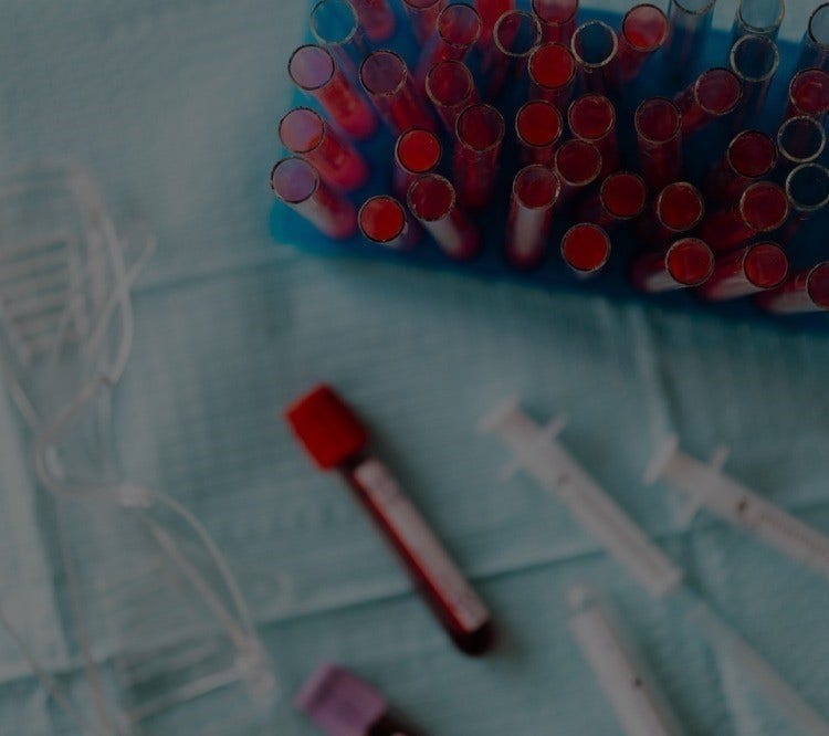 Various medical vials on blue cloth.