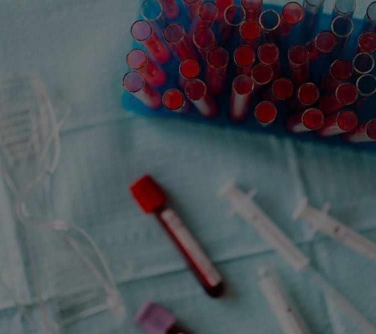 Various medical vials on blue cloth.