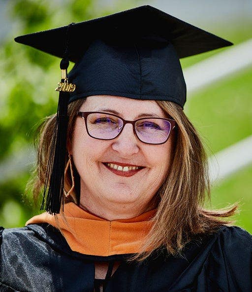 Brenda Dinges in nursing graduation cap and gown