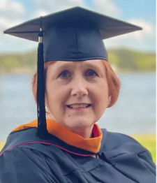 Kathryn Funk at graduation in her cap and gown