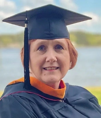 Kathryn Funk at graduation in her cap and gown