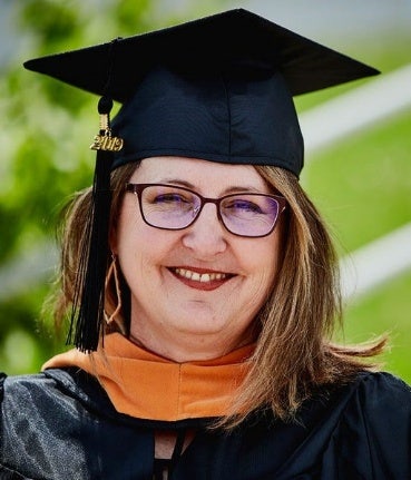 Brenda Dinges in nursing graduation cap and gown